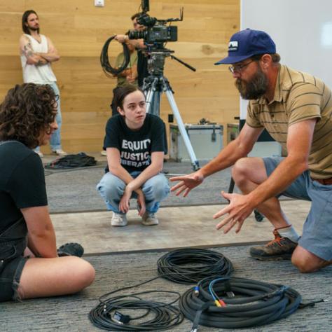 Man working with two participants. 