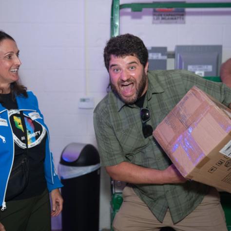 Man laughing with a box.