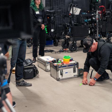 Man working with tape on the floor. 