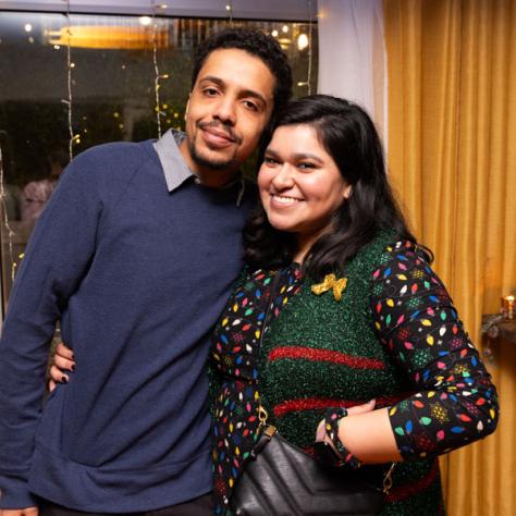 Man and woman posing for photo. 