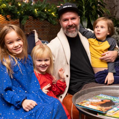 Man and children posing for photo. 