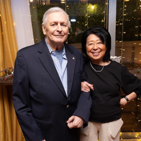 Man and woman posing for photo. 