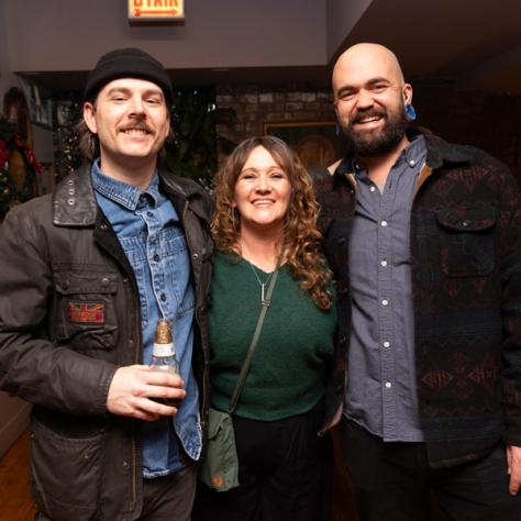 Three people posing for photo.