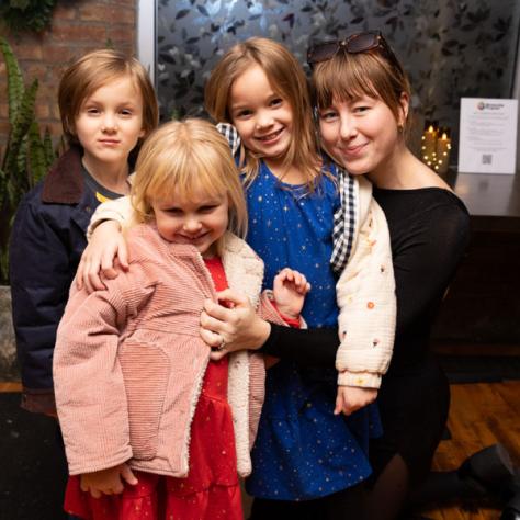 Woman and children posing for photo. 