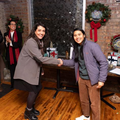 Photo of two women shaking hands. 