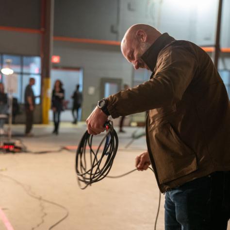 Man with rolled wires. 