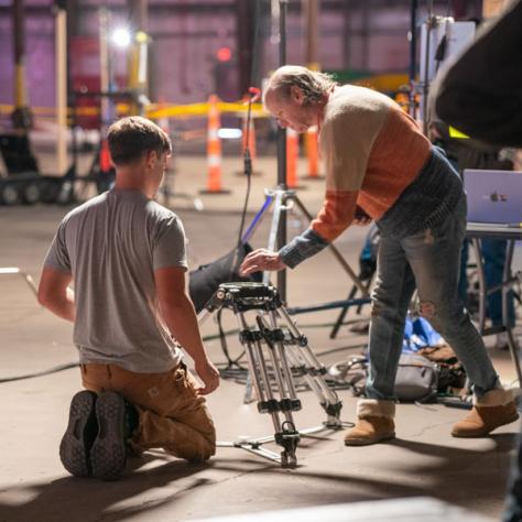 Men working on tripod. 