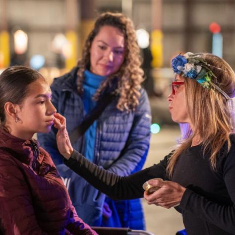 Photo of woman getting makeup done. 