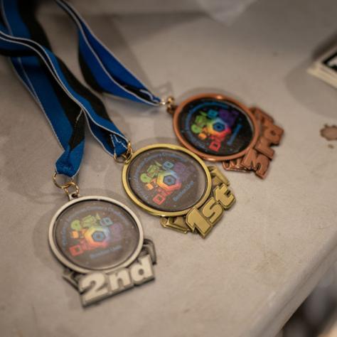 Photo of 1st, 2nd, and 3rd place medals. 