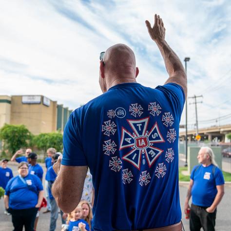 Man waving to crowd. 