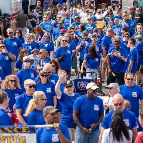 People marching in parade. 