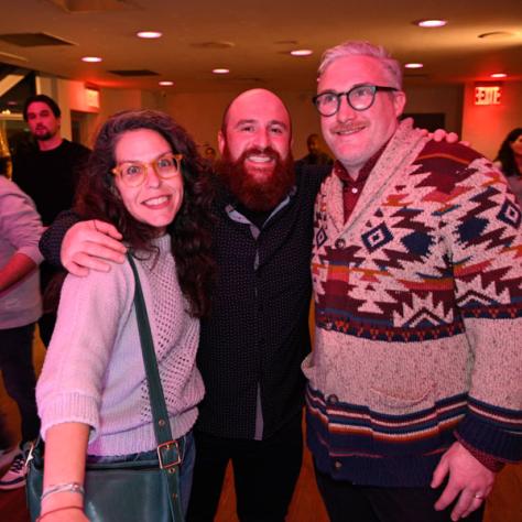 Three people posing for photo. 