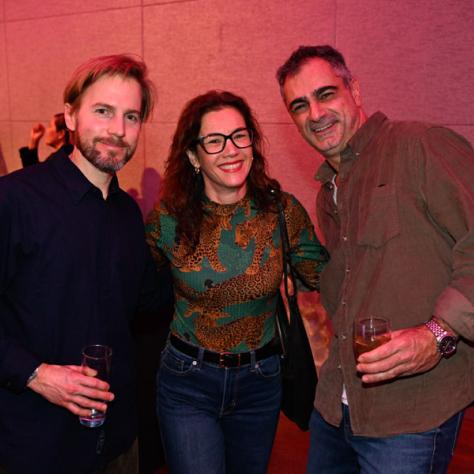 Three people posing for photo. 