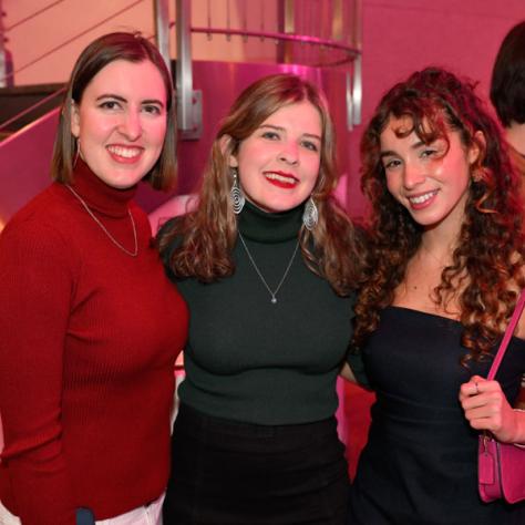 Three people posing for photo. 