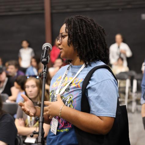 Woman speaking into microphone. 