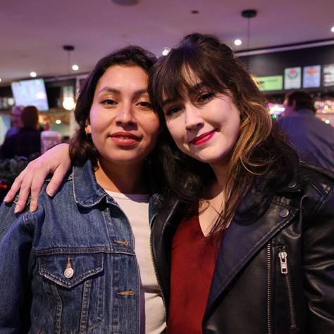 Two women posing for photo. 