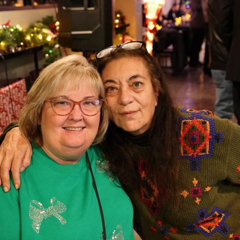 Two women posing for photo. 