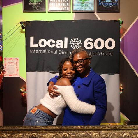 Two women posing for photo. 