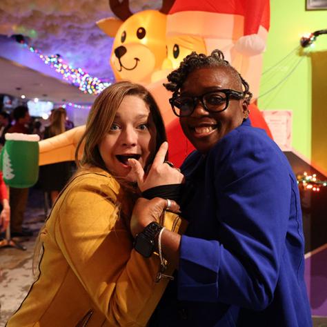 Two women posing for photo. 