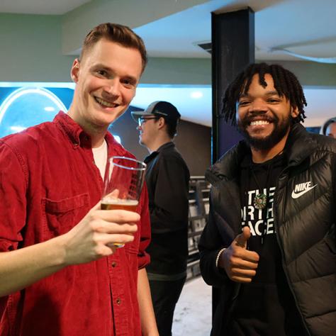 Two men posing for photo. 