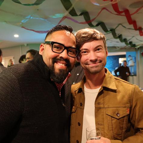 Two men posing for photo. 