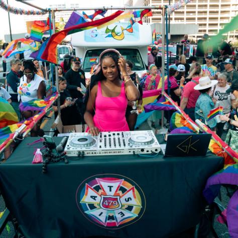 Woman DJing at parade. 