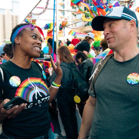 Two people talking at parade. 