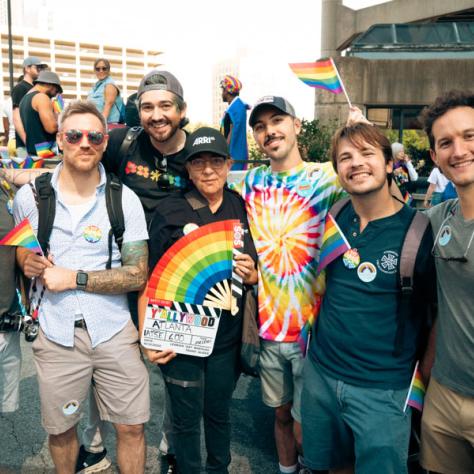 Group of people posing for photo at parade. 