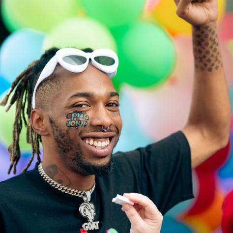 Man posing for photo at parade. 