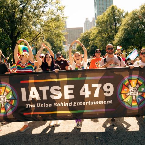 Photo of parade participants with IATSE 479 banner. 