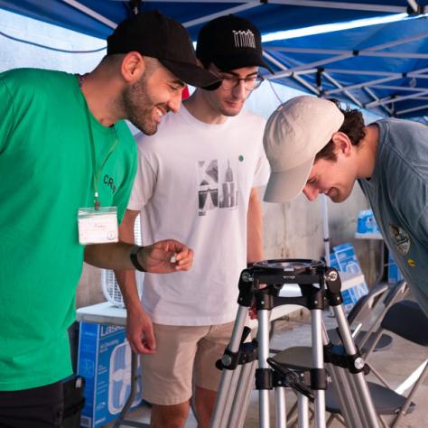 Men working with tripod. 