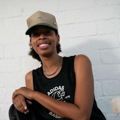 Woman with hat posing for photo. 