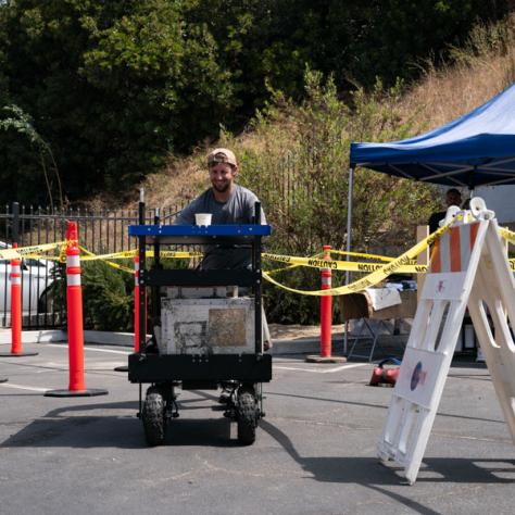 Man with cart outside. 