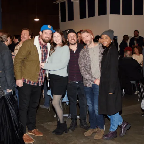 People posing for photo together. 