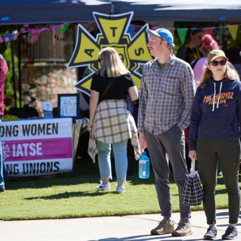 People walking around event outside. 