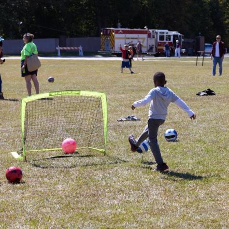 Kids playing soccer outside. 