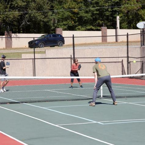 People on tennis court. 