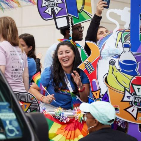 Woman marching in pride parade. 