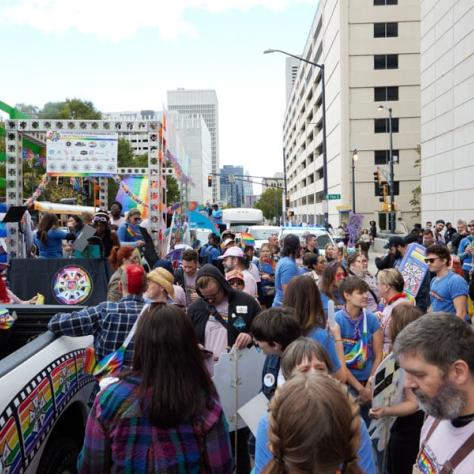 People standing and marching in parade. 