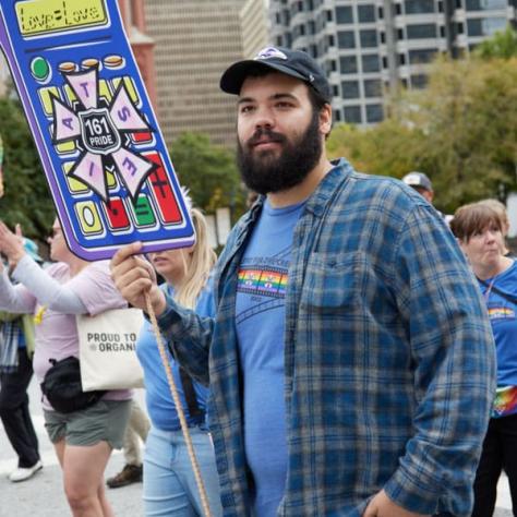 Man with sign at parade. 