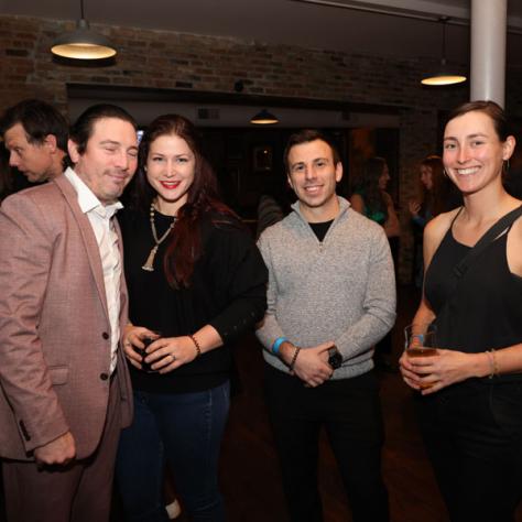 People posing for photo at party.