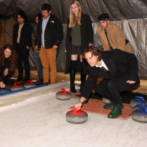 People playing shuffleboard. 