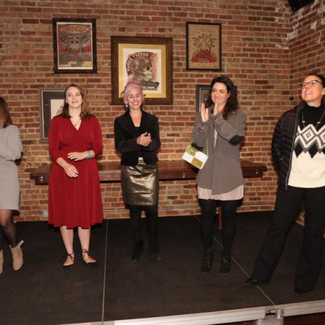 Group of women standing at party. 