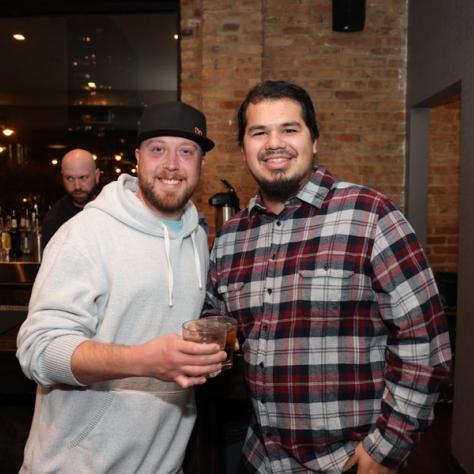 People posing for photo at party.