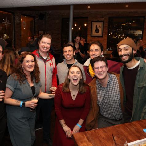 People posing for photo at party.