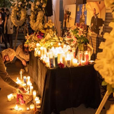 Man lighting candle at vigil. 