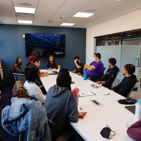 People sitting at a conference table. 