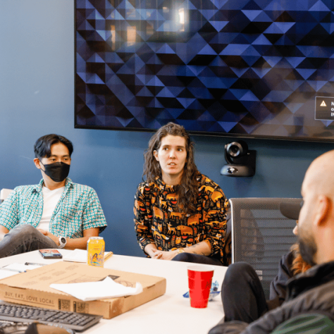 People sitting at conference table. 