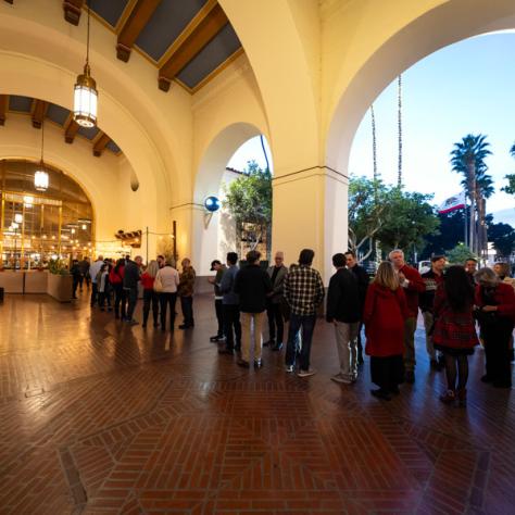 View of partygoers under arches at venue. 