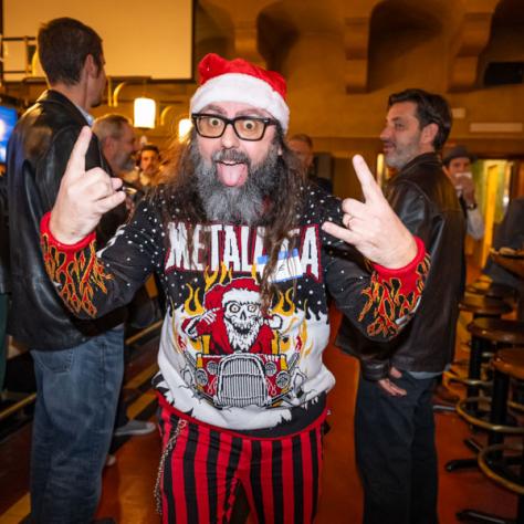 Man posing for photo in Christmas sweater. 